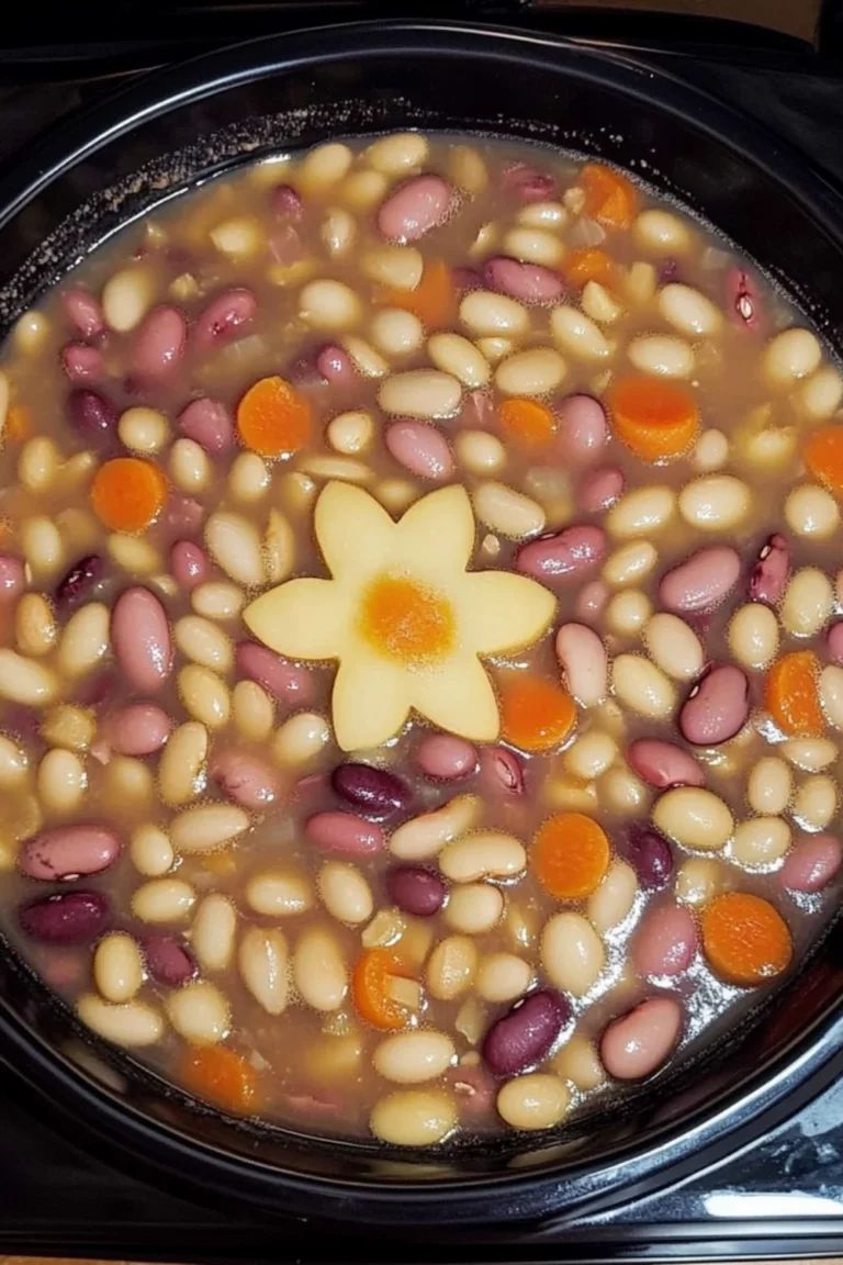 A bowl of Crockpot Great Northern Beans served warm in a white ceramic bowl, with creamy broth and tender beans.